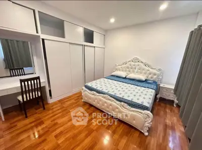 Luxurious bedroom with elegant white furniture and polished wooden floors