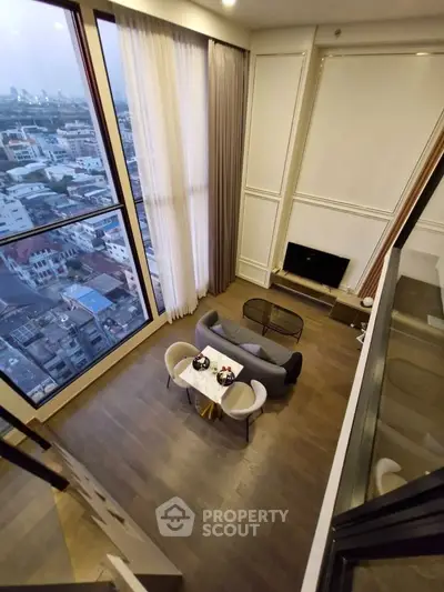 Stunning high-rise living room with floor-to-ceiling windows and breathtaking city view.