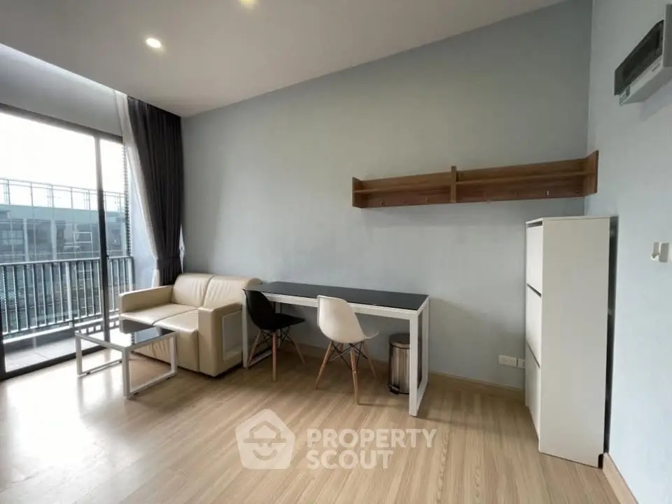 Modern living room with balcony access and stylish furniture