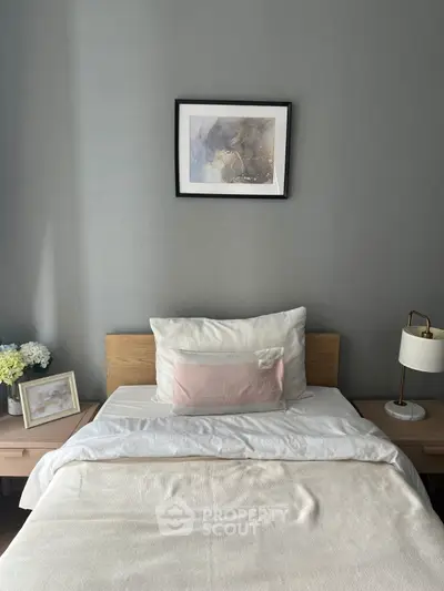 Cozy bedroom with modern decor and soft lighting, perfect for relaxation.