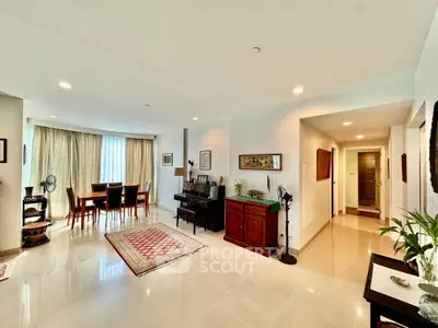 Spacious living room with elegant dining area and modern decor in a luxurious apartment.
