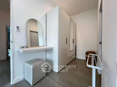 Modern minimalist bedroom with sleek white furniture and stylish decor