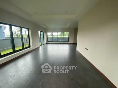 Spacious modern living room with large windows and garden view