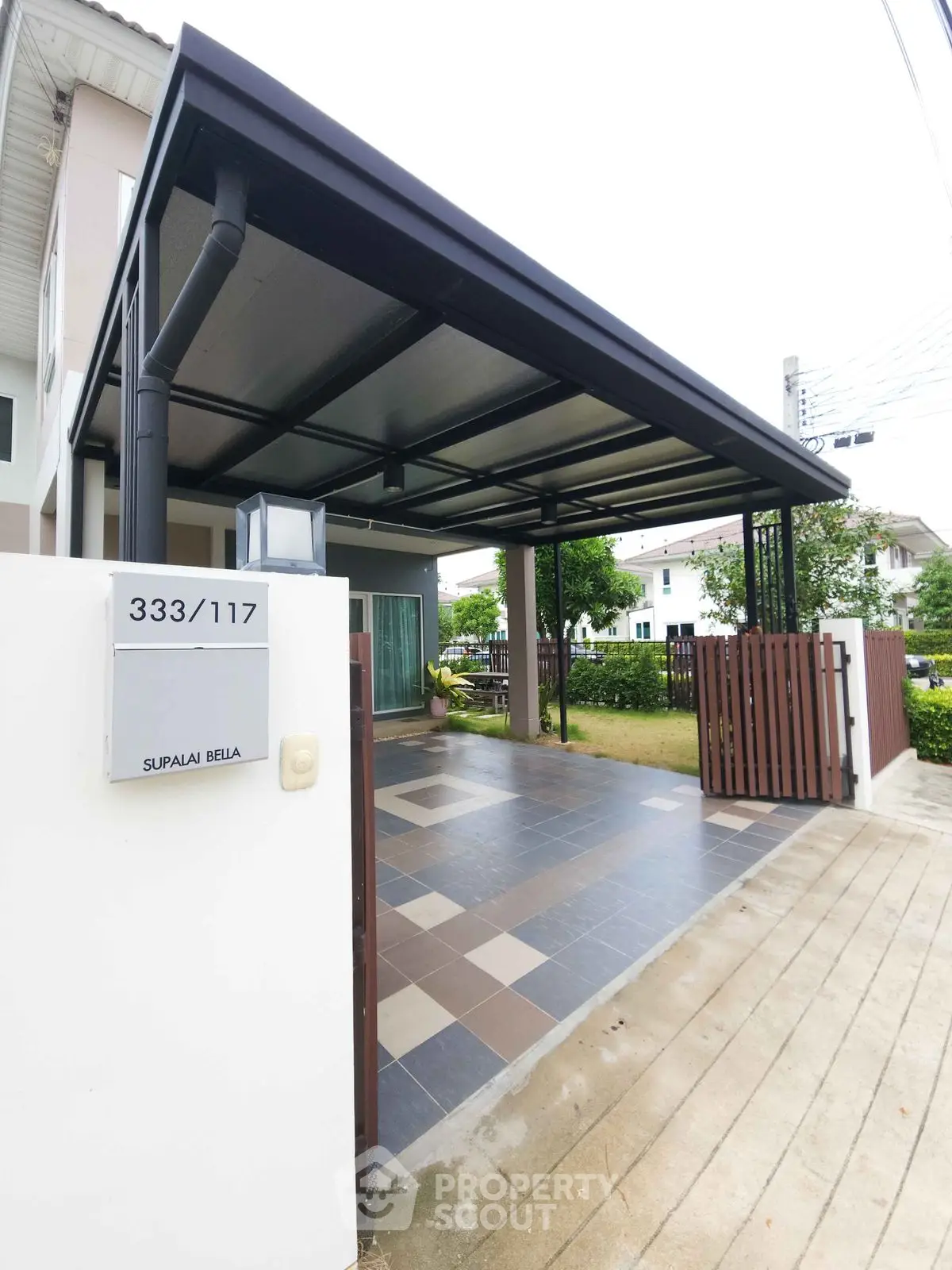 Modern home with covered carport and stylish entrance in a serene neighborhood.