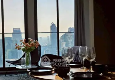 Luxurious dining area with stunning city view through large windows, featuring elegant table setting and modern decor.