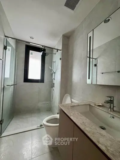 Modern bathroom with sleek fixtures and glass shower enclosure
