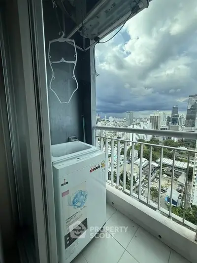 High-rise balcony with washing machine and stunning cityscape view