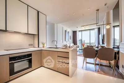 Modern open-plan kitchen and living area with city view, sleek design and elegant furnishings.