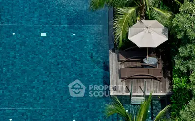 Luxurious poolside retreat with elegant loungers and lush greenery