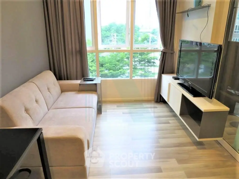 Modern living room with large window and stylish furniture in a cozy apartment.
