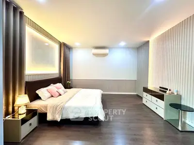 Spacious modern bedroom with elegant decor and ambient lighting