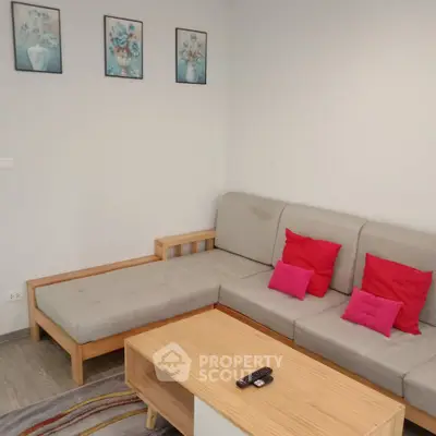 Cozy living room with modern sectional sofa and vibrant decor accents.