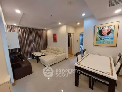 Modern living room with stylish furniture and dining area, featuring elegant decor and ample natural light.