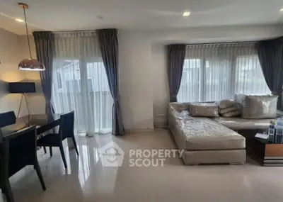 Spacious living room with modern decor and large windows for natural light