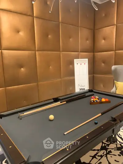 Luxurious billiard room with elegant padded walls and modern decor