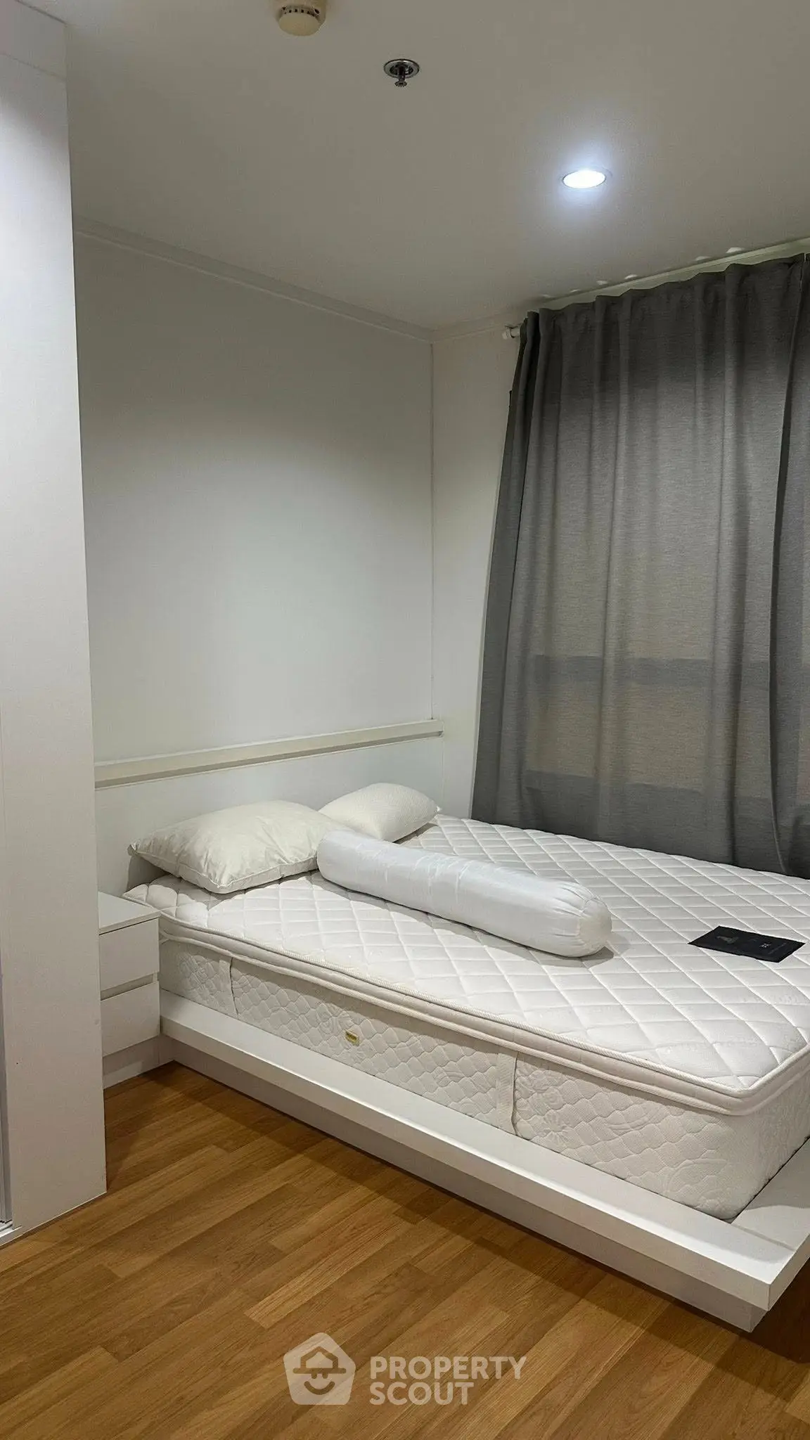 Cozy bedroom with modern decor and natural light, featuring a comfortable bed and stylish curtains.