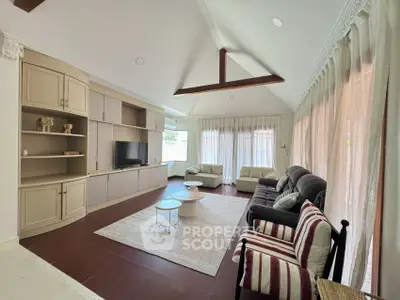 Spacious living room with vaulted ceiling and elegant furnishings