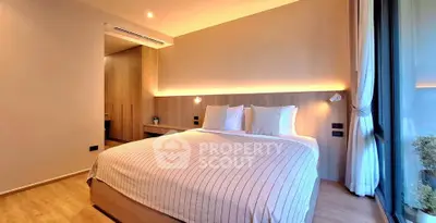 Modern bedroom with cozy lighting and large window view