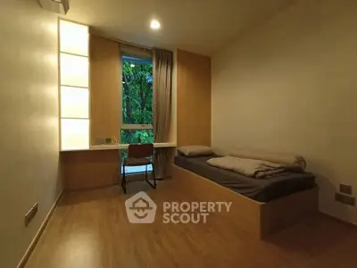 Cozy minimalist bedroom with wooden flooring and garden view