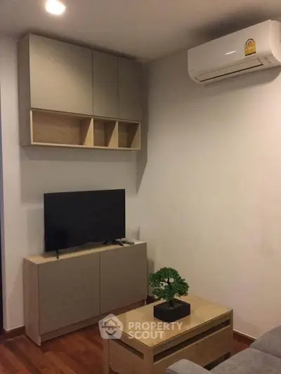 Modern living room with sleek cabinetry and air conditioning unit, perfect for cozy urban living.