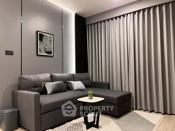 Modern living room with sleek gray sofa and stylish decor