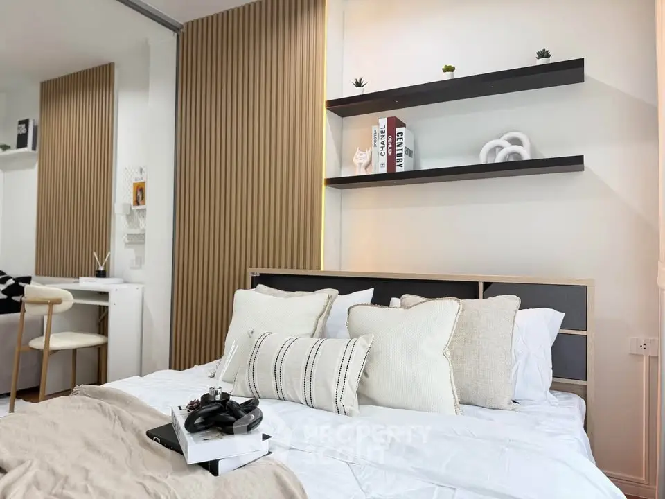 Modern bedroom with stylish decor and cozy bedding in a contemporary apartment.