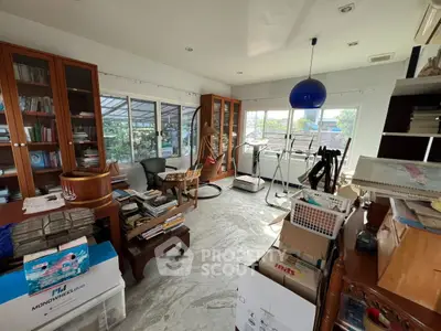 Spacious study room with exercise equipment and ample natural light