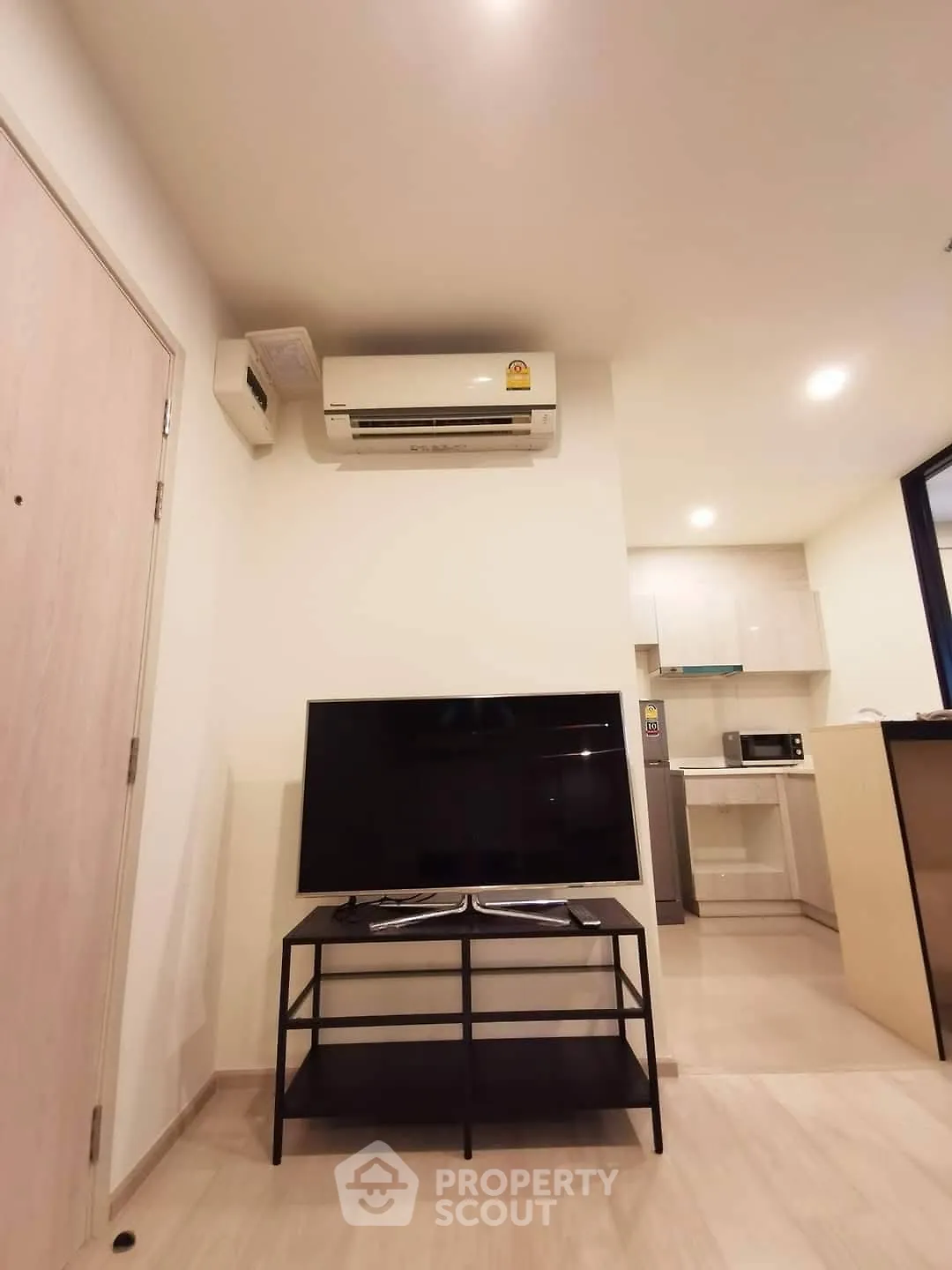 Modern living room with TV and air conditioning in a stylish apartment