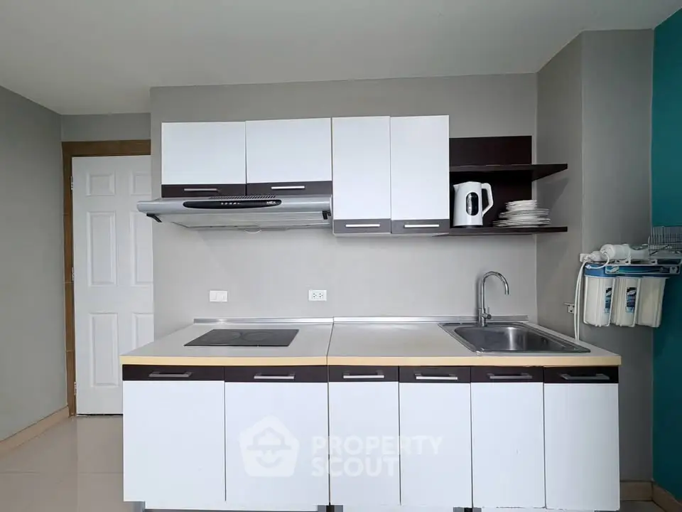 Modern kitchen with sleek cabinetry and built-in appliances in a contemporary apartment.