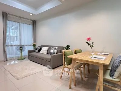 Modern living room with cozy sofa and dining area in a stylish apartment.