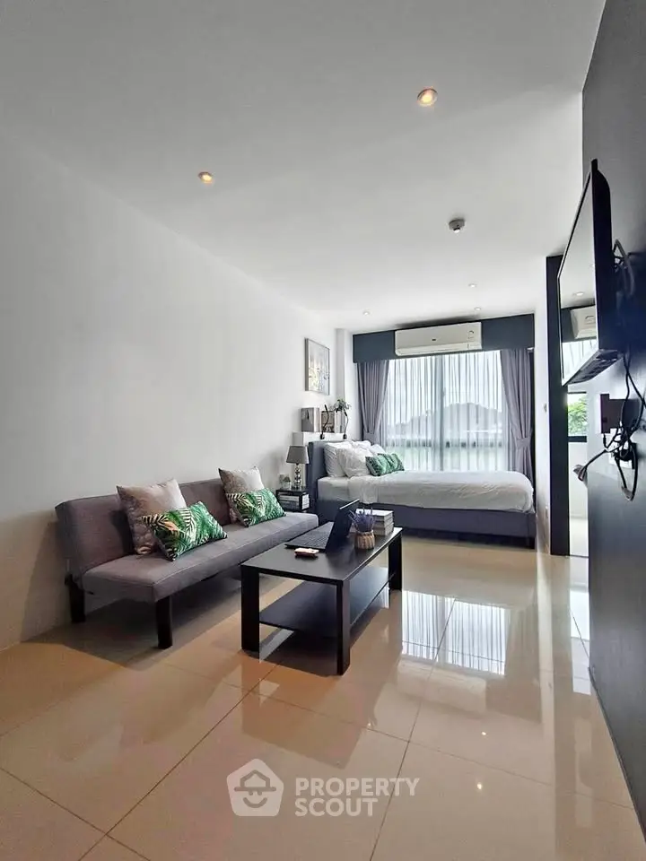 Modern living room with sleek design and natural light, featuring a cozy sofa and stylish decor.