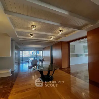 Spacious modern living room with elegant wooden flooring and ceiling lights