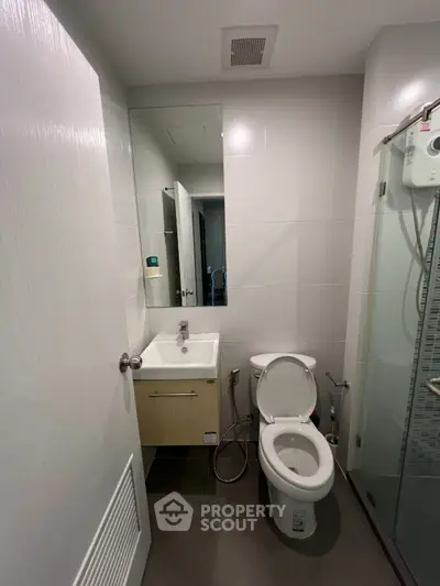 Modern bathroom with sleek fixtures and glass shower enclosure