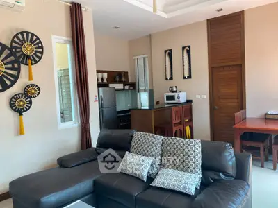 Stylish living room with modern decor and open kitchen layout in a cozy apartment.