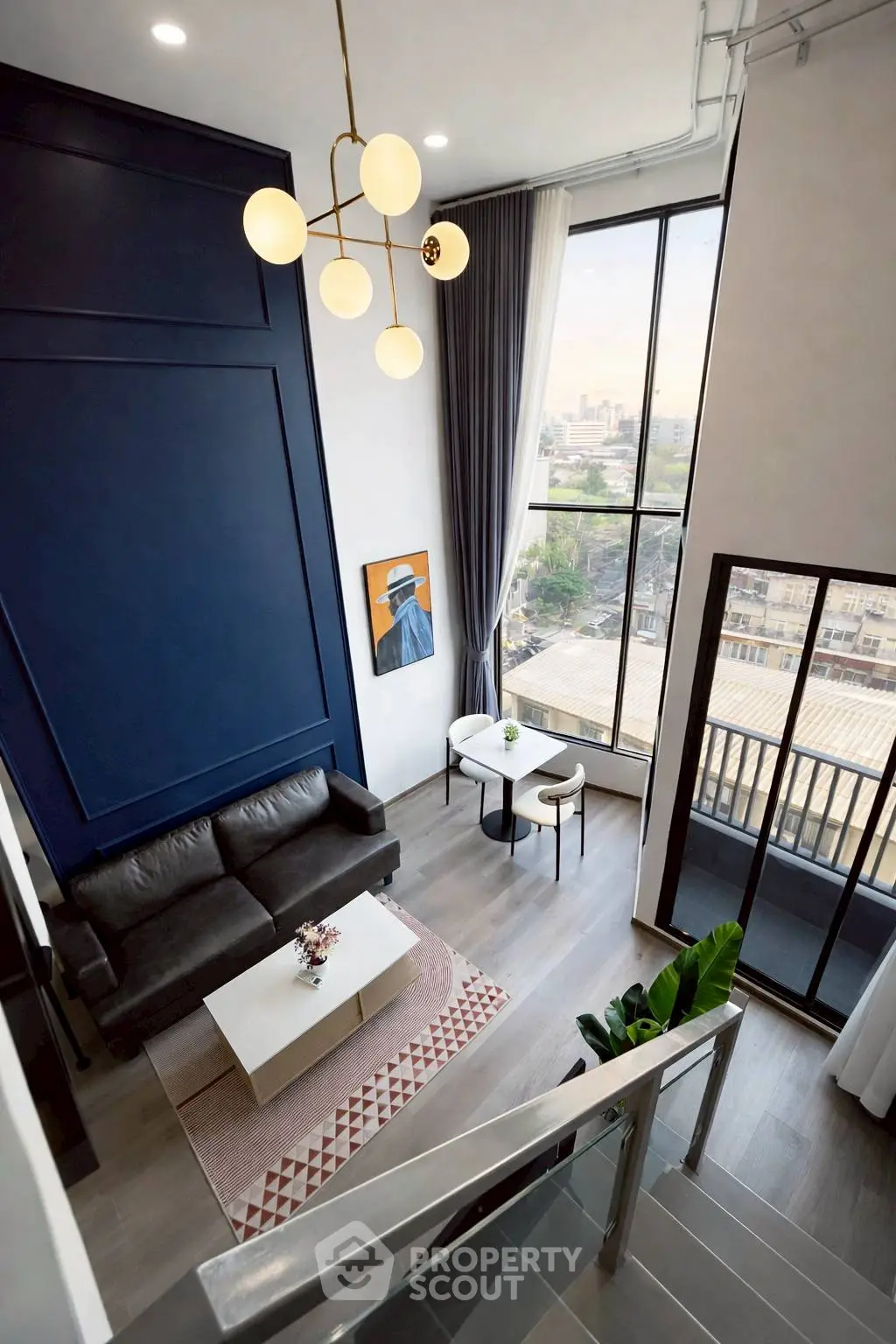 Stunning modern living room with high ceilings and large windows offering city views.