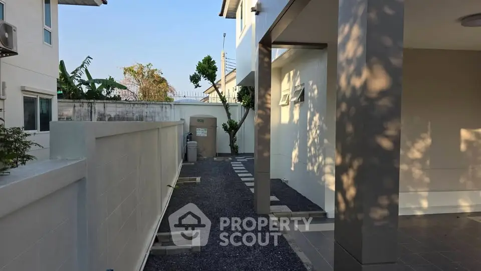 Modern residential exterior with sleek design and spacious outdoor area.