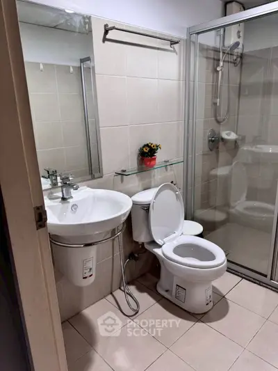 Modern bathroom with glass shower and sleek fixtures in a contemporary home.