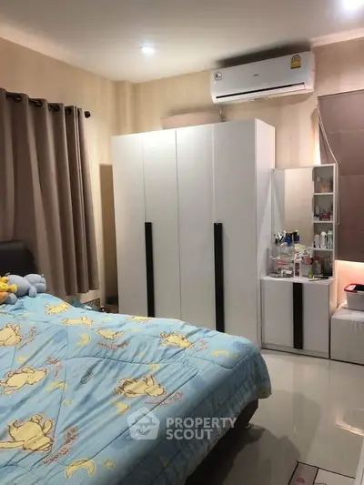 Cozy bedroom with modern wardrobe and air conditioning, perfect for relaxation.
