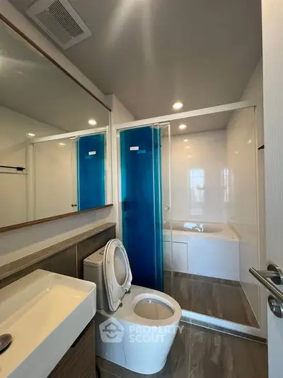 Modern bathroom with sleek fixtures and glass shower enclosure