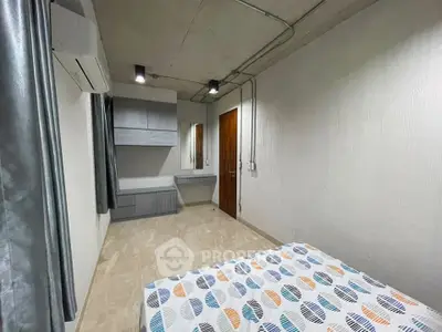 Modern bedroom with stylish decor and ample natural light, featuring sleek furniture and contemporary design.