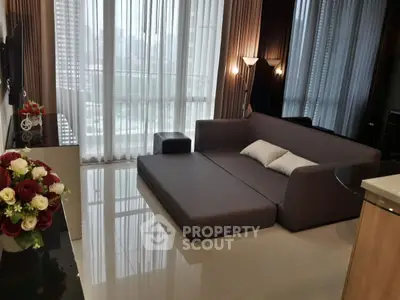 Modern living room with sleek sofa bed and floor-to-ceiling windows