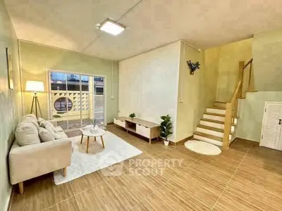 Spacious living room with modern decor and staircase in a stylish home