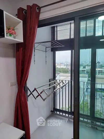 Modern balcony with city view and laundry rack, perfect for urban living.