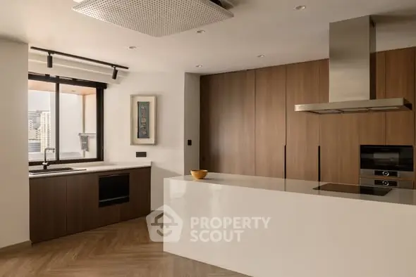 Modern kitchen with sleek cabinetry and built-in appliances in a stylish apartment.