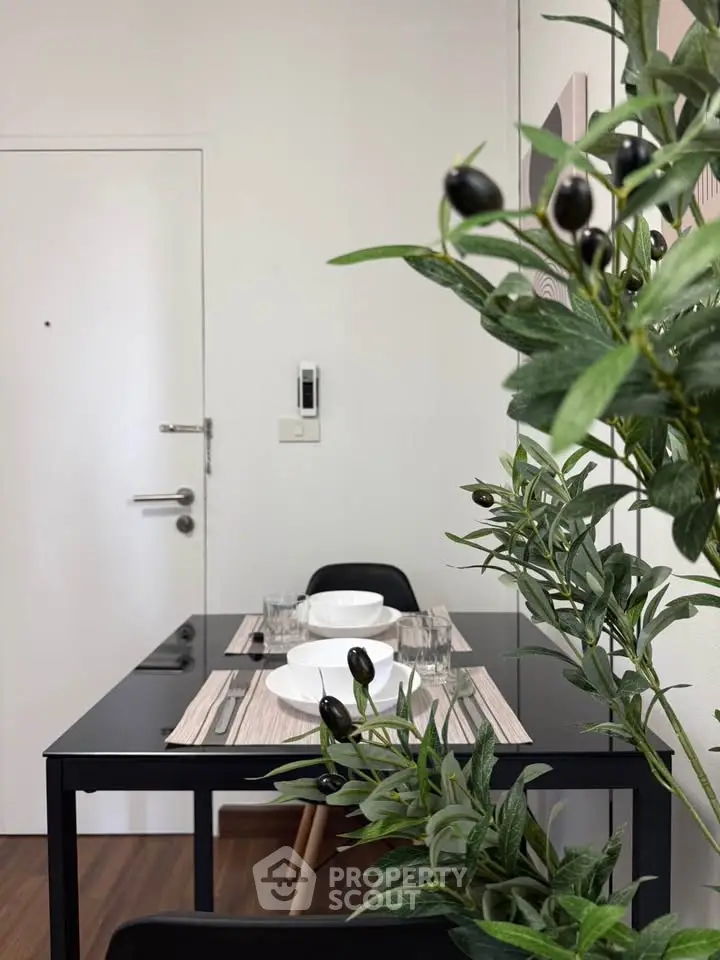 Modern dining area with sleek black table and elegant tableware