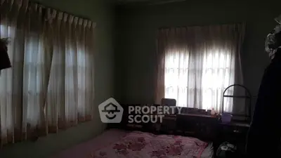 Cozy bedroom with soft lighting and floral bedding, perfect for relaxation.