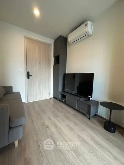 Modern living room with sleek furniture and air conditioning