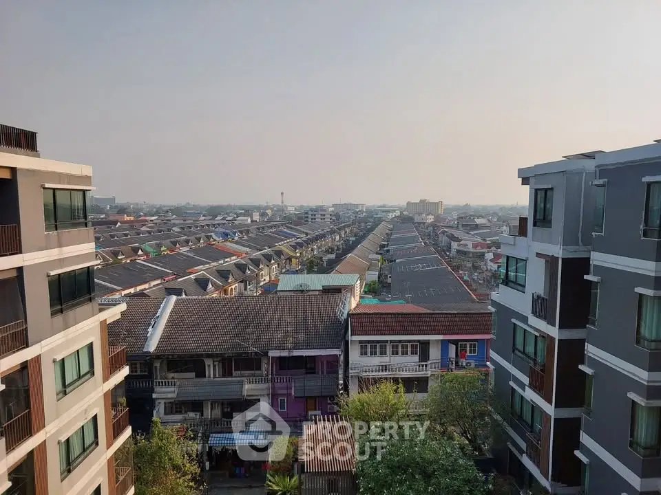 Stunning aerial view of urban residential area with modern buildings and clear sky, showcasing vibrant city living.