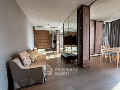 Spacious modern living room with elegant decor and mirrored wall