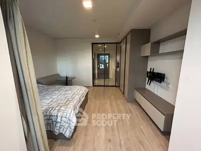 Modern bedroom with sleek design and ample storage in a contemporary apartment.